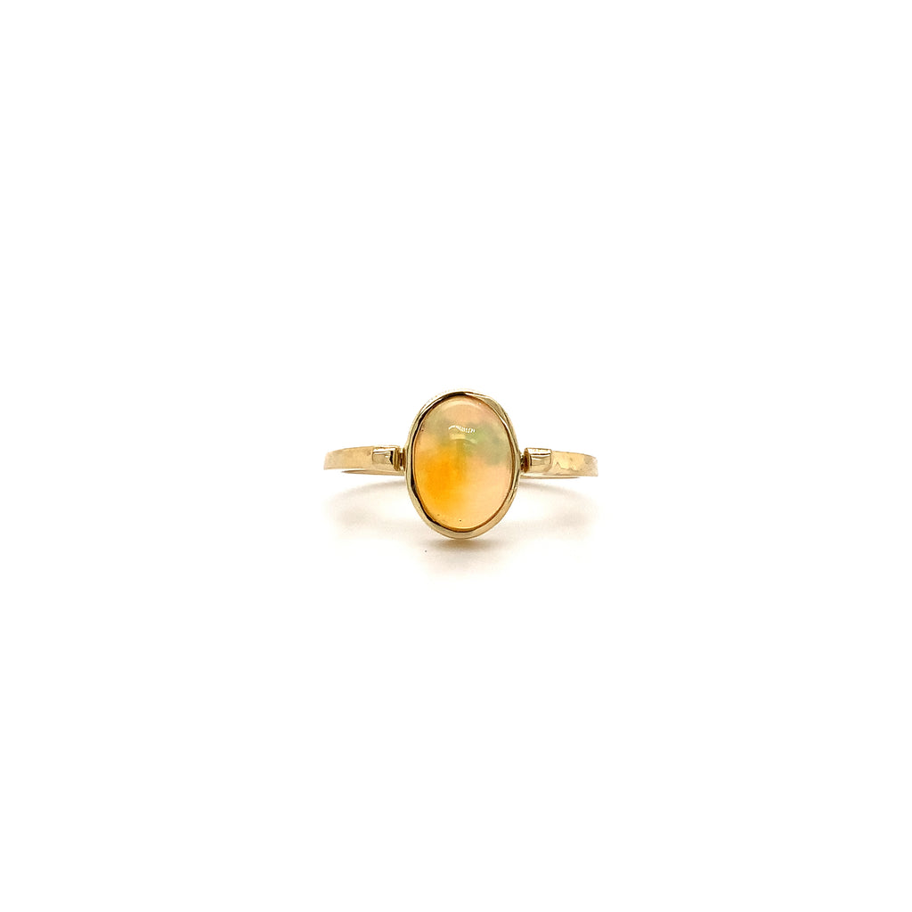 hand made petite fine crystal opal bezel set ring. set in 18k yellow gold