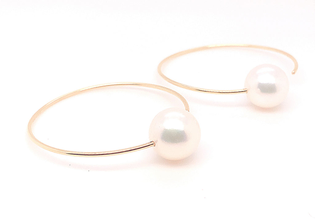 white freshwater pearl on handmade round wire earrings in 14k of yellow gold