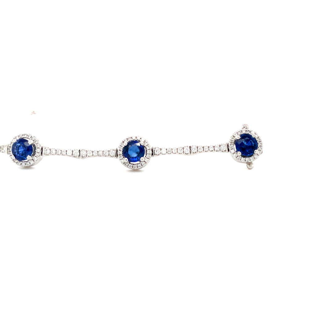 straight line ceylon sapphire and diamond halo bracelet set in 18k white gold.