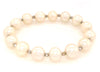 white fresh water pearl bracelet with 14kt white gold multifaceted 3mm beads on stretchable cord